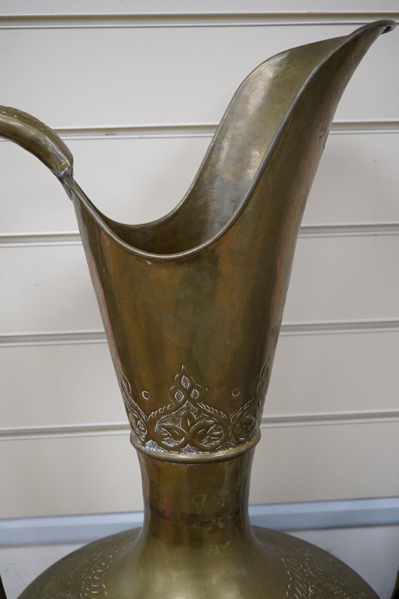 A large Indian brass ewer, 73cm tall. Condition - fair to good